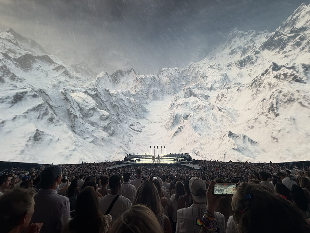 Backstreet Boys on stage, huge video of snowy mountains on screen