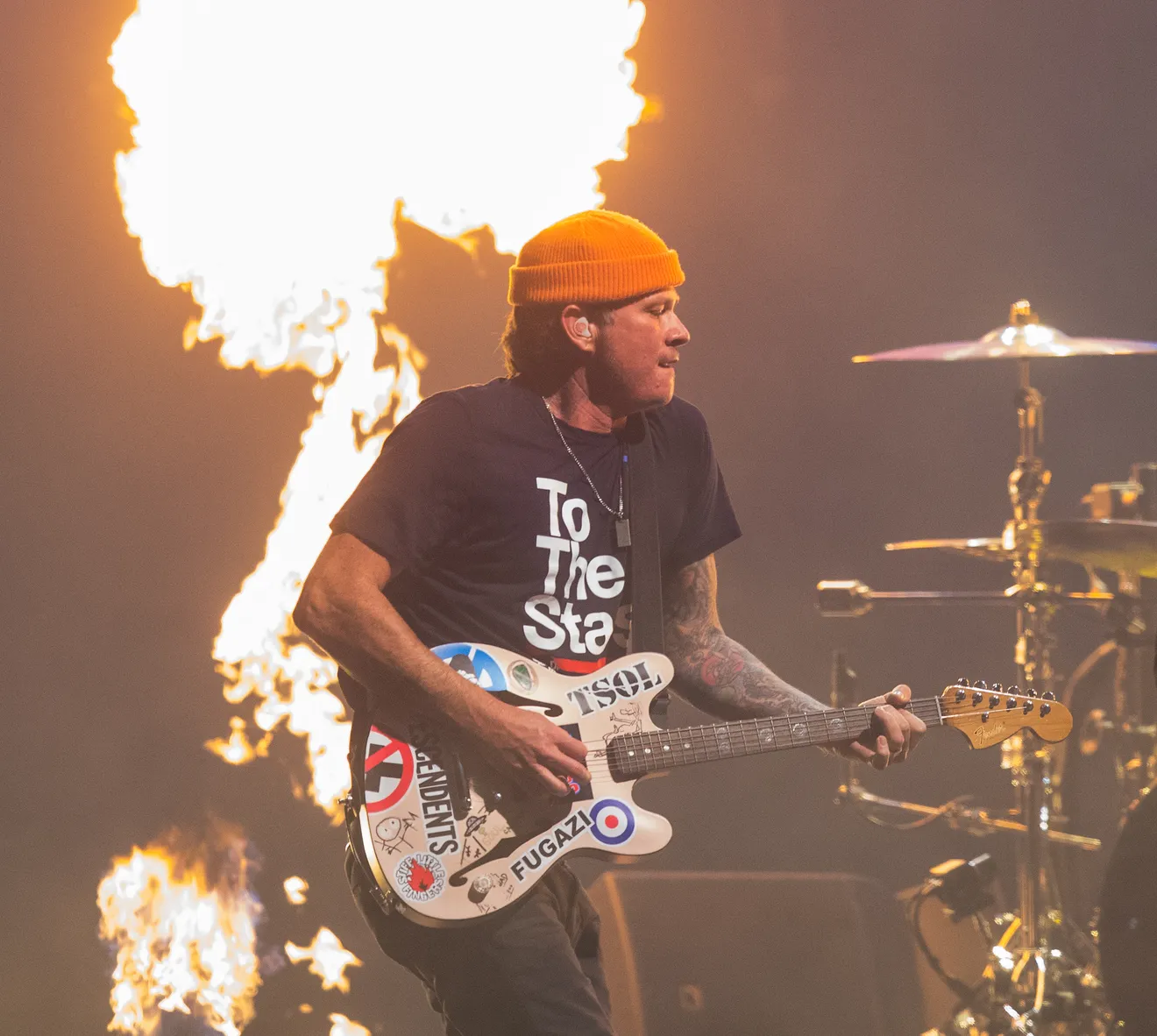 Tom playing with a big flame behind him