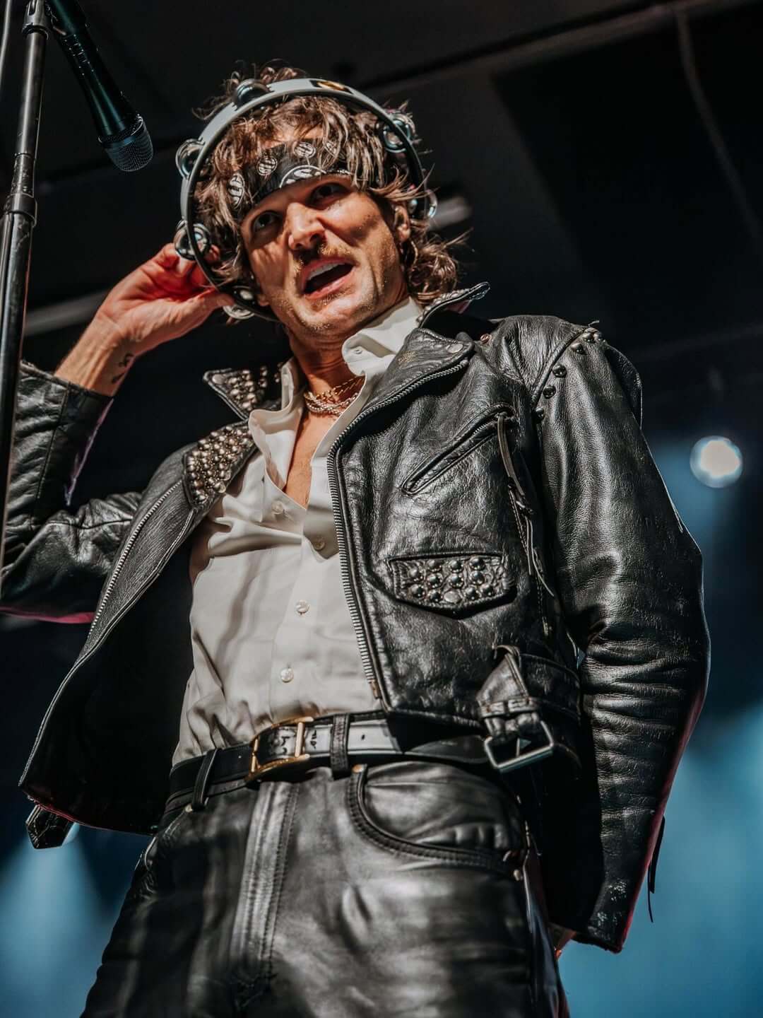 Martin holding a tambourine over his head like a crown