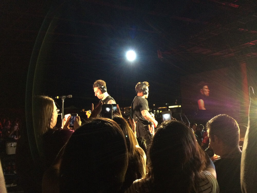 Joe and Pete of Fall Out Boy playing in the mixing booth area