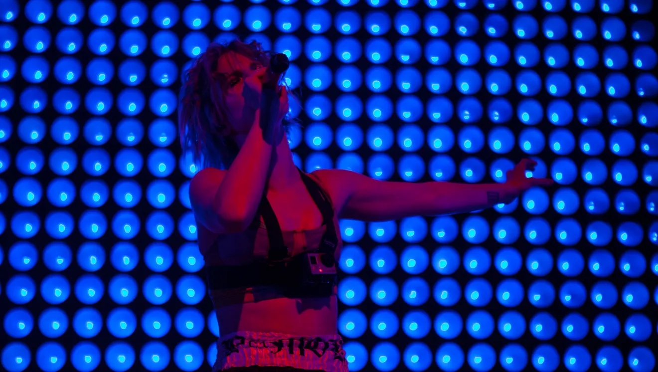 Hayley in front of a wall of blue lights