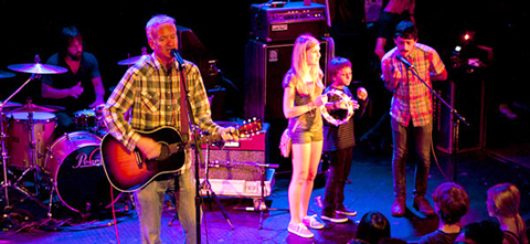 Chris Collingwood on stage with some young folks