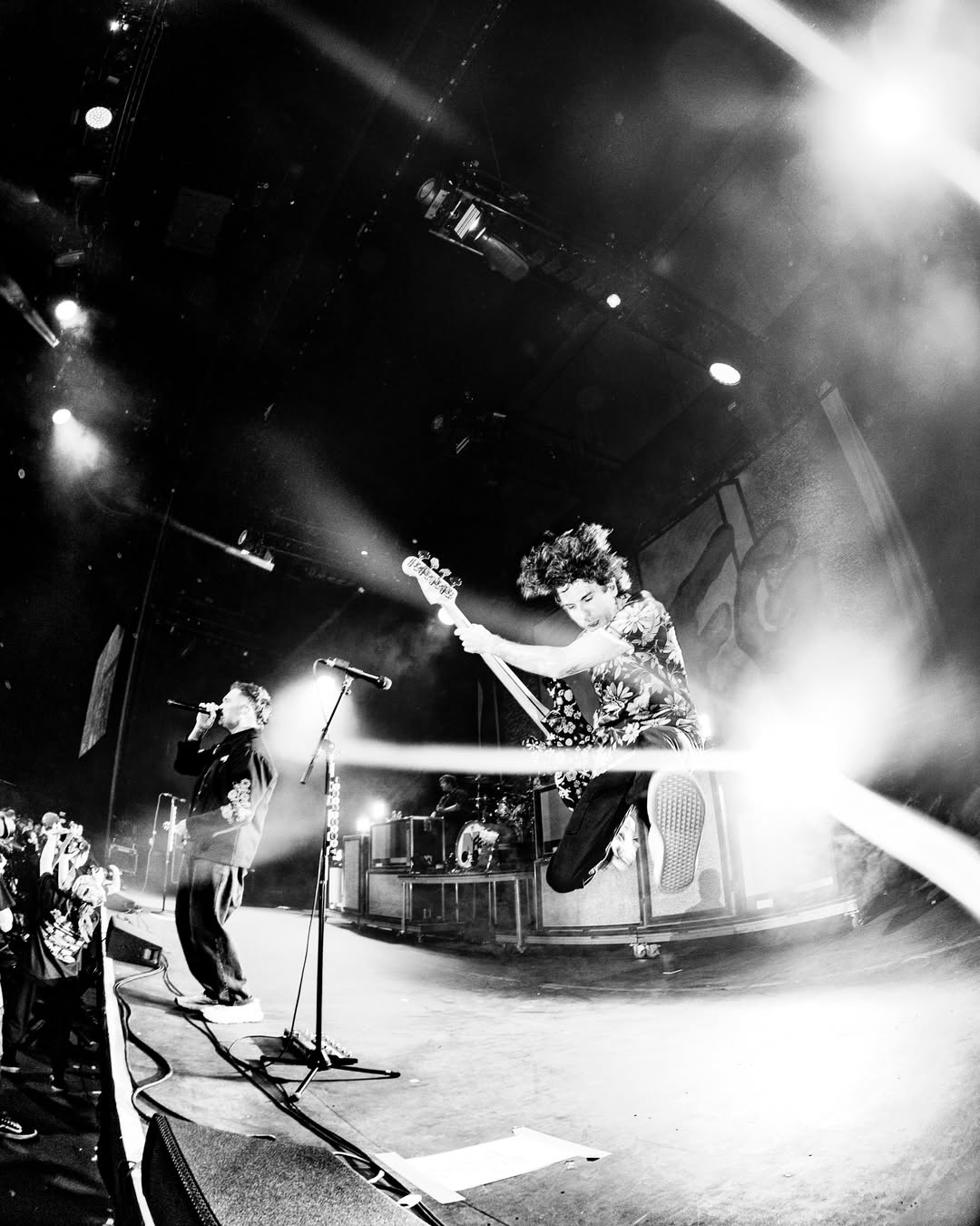 Jordan singing and Dave Knox doing a jump on bass