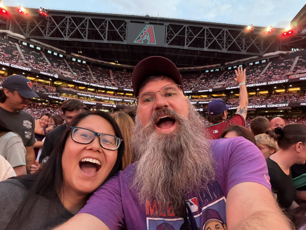Lynn and Clay selfie from the field with Chase Field crowd behind