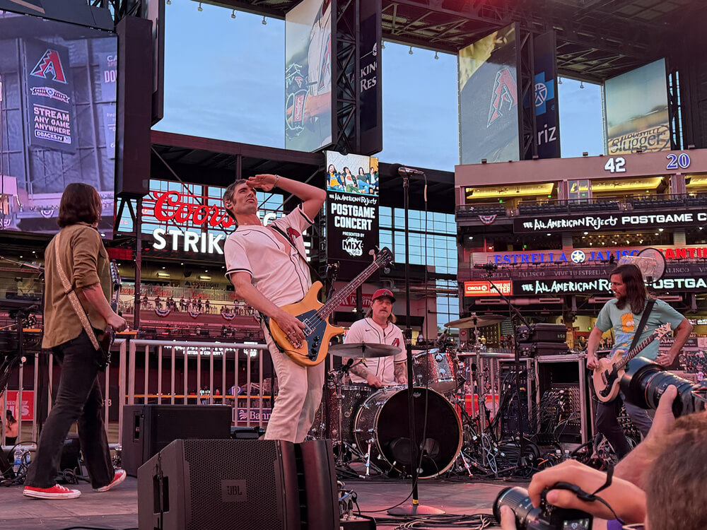 The All-American Rejects on stage, Tyson is giving a salute to the upper levels