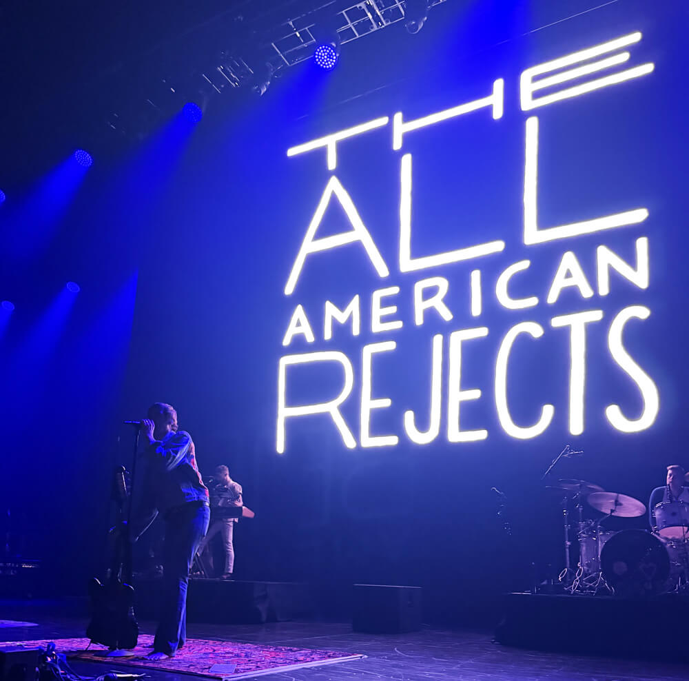 Tyson on stage with huge AAR logo on the screen behind