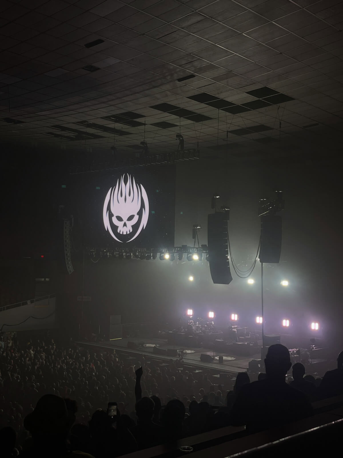 dark stage with huge The Offspring logo