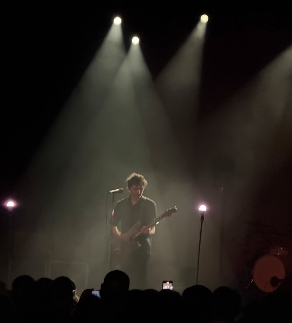 Kenny illuminated by spotlights