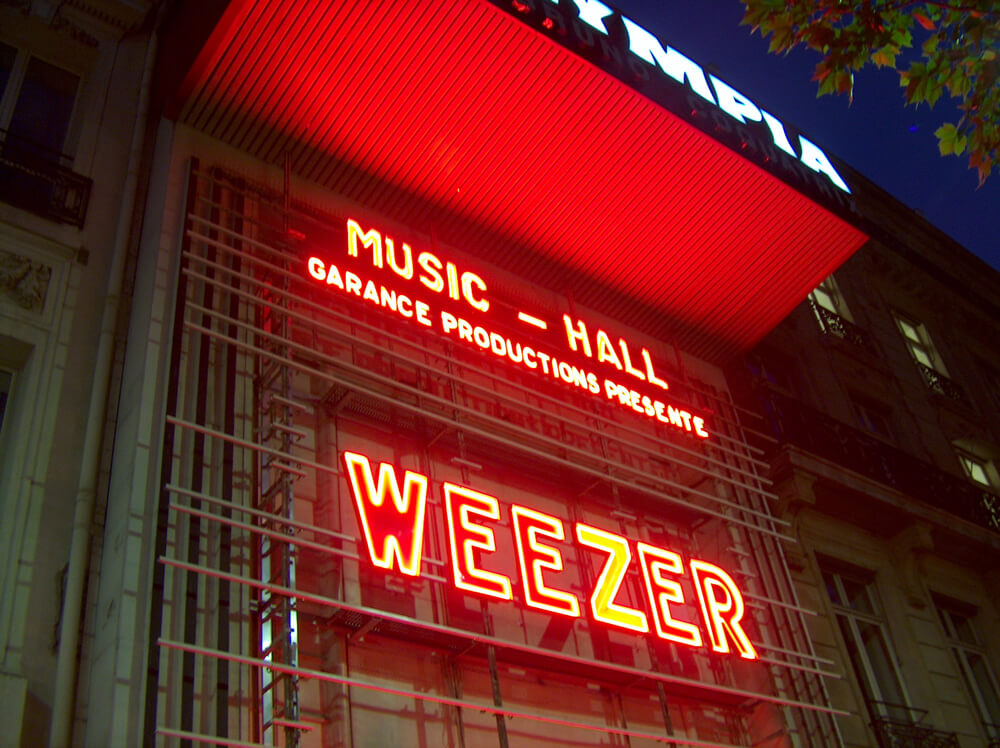 outside of L’Olympia with huge Weezer neon sign